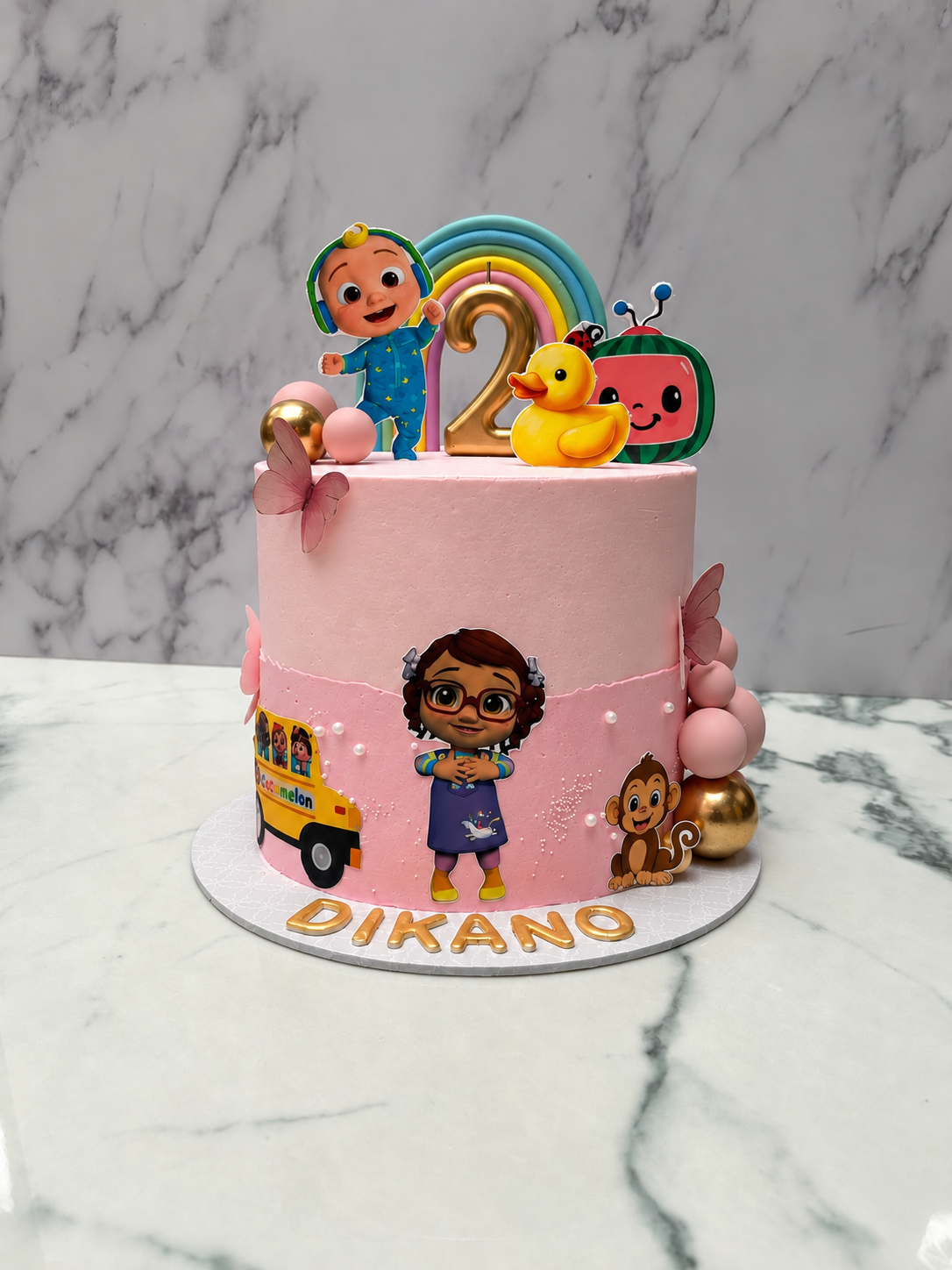 Pink Cocomelon second birthday cake for Dikano